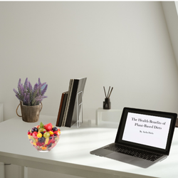 minimalist desk with plant-based food and plant-based content