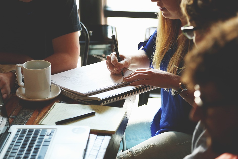 A group meeting where they are writing down their ideas.